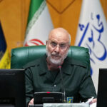 Iran defies US, reviews plan but refuses negotiations